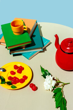 Modern conceptual still life with tea book cherry and rose