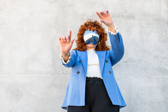 Professional in blue blazer interacting with virtual reality outdoors