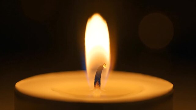 Pentecost celebration with single lit candle on table indoors