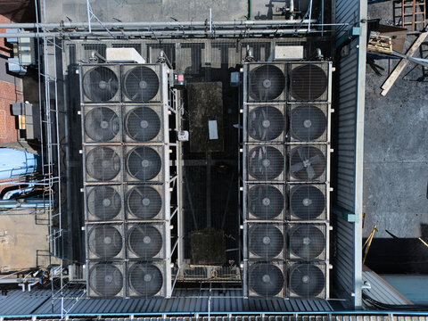 Aerial view of industrial HVAC cooling fans and ventilation systems on a factory rooftop in Knottingley, England, United Kingdom.