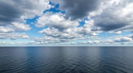 Fototapeta premium Expansive view of a massive freshwater lake where deep blue waters meet the cloudy, atmospheric horizon, emphasizing the large scale of the shoreline ,summer ,serene ,pebbles