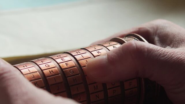 Macro close-up of thumbs turning a cryptex, evoking suspense, cryptography, and the pressure of solving a hidden code or unlocking a secret.