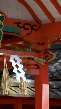Traditional Vermilion Shinto Shrine Gate with Shimenawa Rope in Kyoto Japan