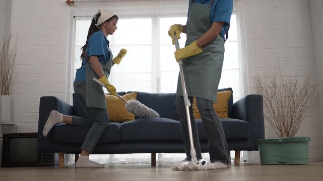 Housekeepers are cleaning a living room. Occupation, Blue collar worker.