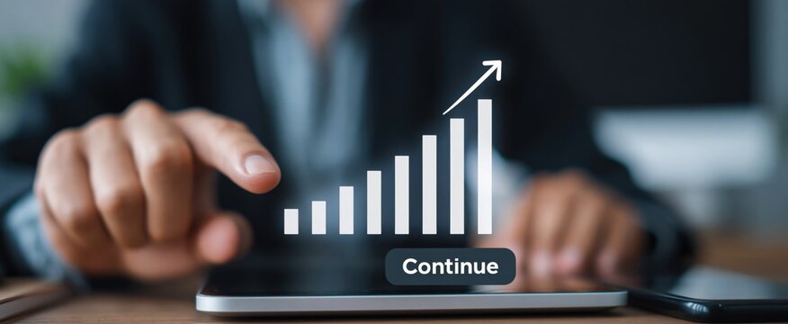 Entrepreneur engaging with virtual growth chart and &ldquo;Continue&rdquo; button on desktop and smartphone. Concept of business strategy, planning, and digital workflow.