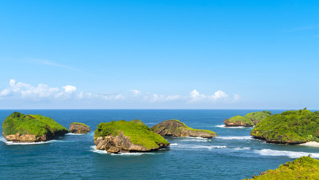 Panoramic view of karst island cluster at Kasap Beach, Pacitan Indonesia during summer morning, tropical island landscape with blue ocean. copy space