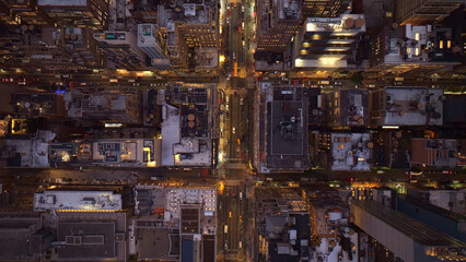 Dramatic aerial view of a vibrant city at night, illuminated urban landscape with glowing streetlights and building windows, high-angle cityscape for modern architecture and travel themes © Kuch_Bhi