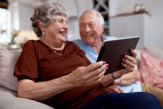 Tablet, hands and senior couple on sofa, movie website or digital subscription service for streaming. Smile, connection and old people with tech for online entertainment, film app or internet in home
