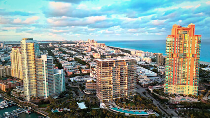 Vibrant Miami cityscape aerial view, modern coastal architecture, luxury high-rise buildings, oceanfront skyline, urban development, travel destination, real estate, and tourism. © Joe