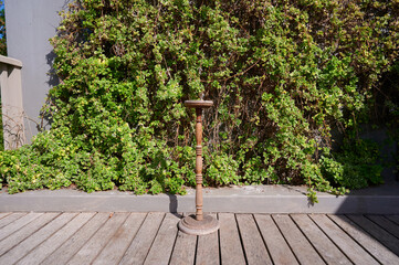 Wooden stand sitting on deck in front of greenery © khmelev