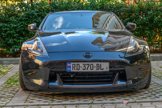 Tbilisi, Georgia, 10.29.2025 Black Nissan 370Z on Residential Complex Parking under Trees