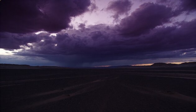 Dominating storm cloud bank releasing rain shaft over plain at twilight, with tire tracks and mesas
