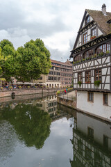 Obraz premium Canal with colorful houses and reflections in Strasbourg France