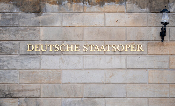 Deutsche Staatsoper or Berlin State Opera sign. Neoclassical opera house on Unter den Linden boulevard on April 21, 2026 in Berlin, Germany.