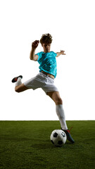 Obraz premium Teal jersey soccer player leaping over ball on grass field with copy space. Concept of sports ads, training promo, youth league banners, athletic motivation and active lifestyle campaigns.
