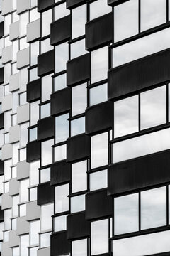Monochrome grid balcony geometry and abstract pattern on urban apartment building facade architecture in spain with modern residential exterior detail