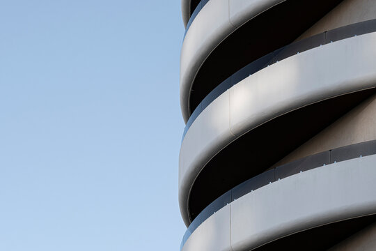 Spiral curves emphasize balcony geometry and abstract pattern on urban apartment building facade architecture in spain with modern residential exterior detail