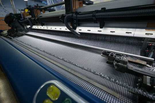 A machine for the production of fabrics. Automatic loom at the factory