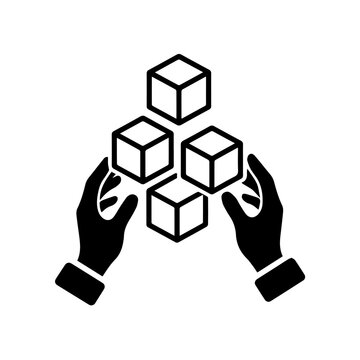 Hands holding four cubes in a triangular formation from below