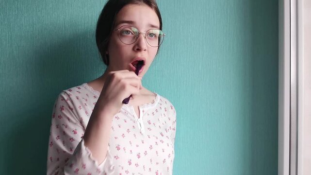 Teen girl brushing teeth in bathroom, daily hygiene routine, fresh smile and dental care concept.