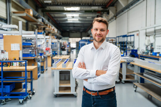 Confident manager smiling in modern production hall