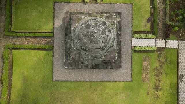 Ancient stone temple in a lush green garden. 4K high-quality heritage footage of Java, Indonesia.