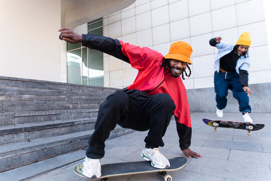 Friends skateboarding and jumping in urban Barcelona