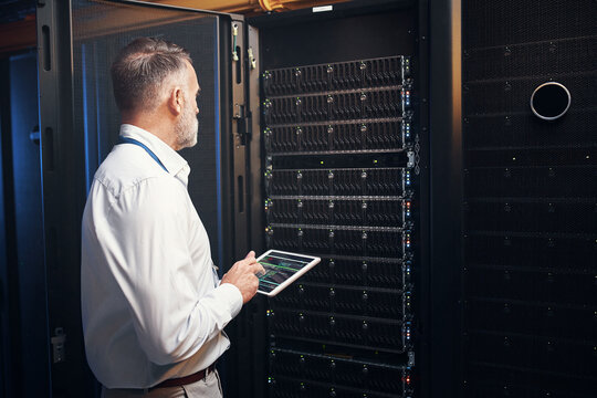 Man, tablet screen and rack inspection in server room for system health, hardware audit or backup. IT engineer, mature person or tech in data center for maintenance, diagnostic code and cybersecurity