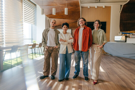 Business team smiling and standing in a bright modern office