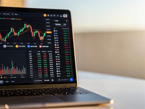 Cryptocurrency trading dashboard on a laptop