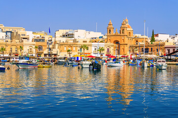 Naklejka premium Malta, Marsaxlokk. Traditional fishing boats in the Mediterranean Village.