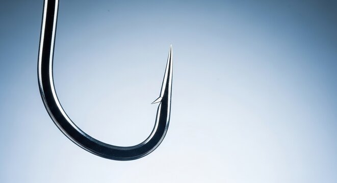 A detailed close-up of a sharp metallic fishing hook featuring a curved shank and pointed barb, designed for professional outdoor angling, chrome, sport, stainless