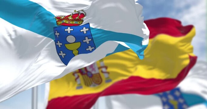 Flags of Galicia and Spain waving on a clear day. Autonomous community of Spain. Seamless 3d render animation. Slow motion loop. Selective focus