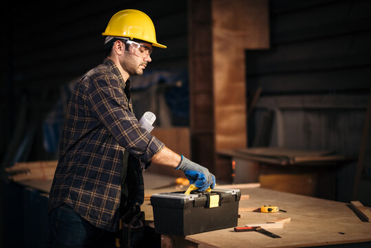 Carpenter Using Tools On Workbench In Workshop Performing Manual Carpentry Task For Industrial Production And Professional Manufacturing Process Environment