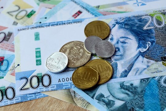 Peruvian sol money bills and coins on table. Peru cash of PEN currency