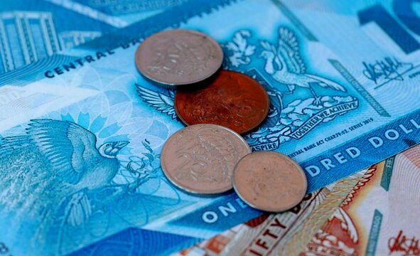 Trinidad and Tobago dollar money bills and coins on table. Trinidad and Tobago cash of TTD currency