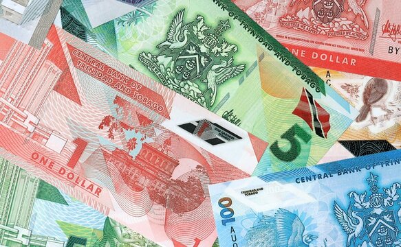 Trinidad and Tobago dollar money banknotes bunch on table. Trinidad and Tobago bills of TTD currency