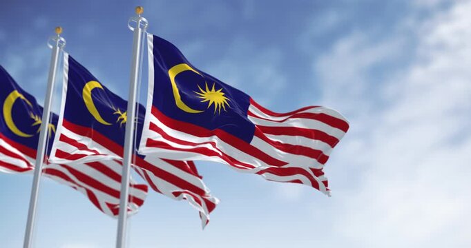 Malaysia national flags waving in the wind on a clear day. Malaysia is a federal state in Southeast Asia. Seamless 3d render animation. Slow motion loop. Selective focus
