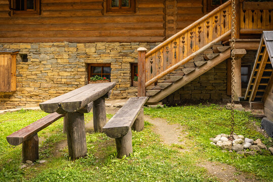 Rustic simple seating area with wooden benches and table