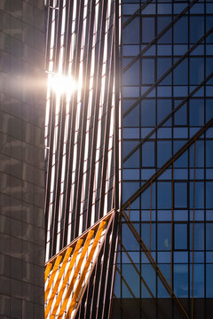Bathed in sunlight this architecture facade in paris la defense turns glass lines and pattern into abstract geometry with a refined urban presence
