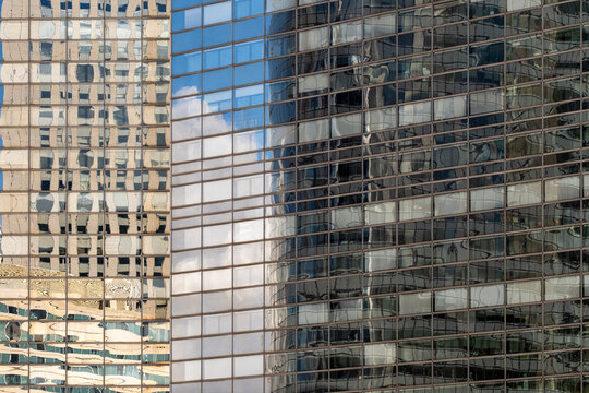 Across paris la defense this architecture facade uses glass reflections and windows to create abstract geometry and pattern with corporate clarity