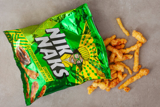 Nik Naks chutney flavored maize snack with pieces spilling on neutral background South Africa editorial