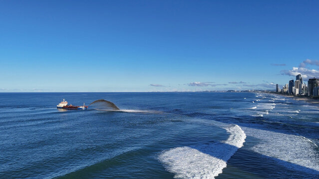 Aerial view of a dredger ship pumping sand near Gold Coast beach