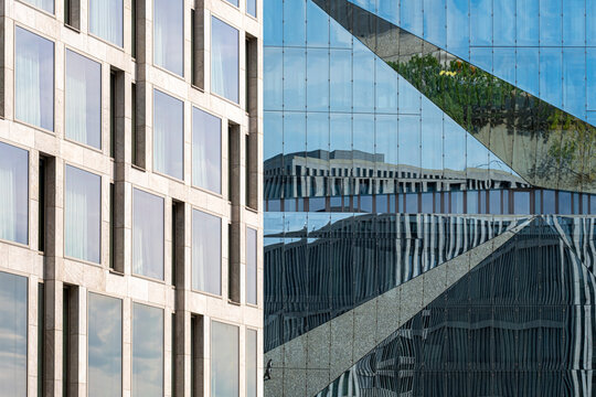 Diagonal windows on a glass facade catch reflections adding geometry and pattern for modern abstract background in architecture design layouts