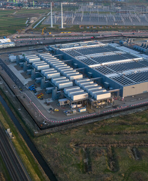 Aerial view of a large modern data center facility with rows of cooling units and industrial infrastructure Netherlands.