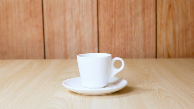 White Ceramic Coffee Cup and Saucer on Light Wood Table