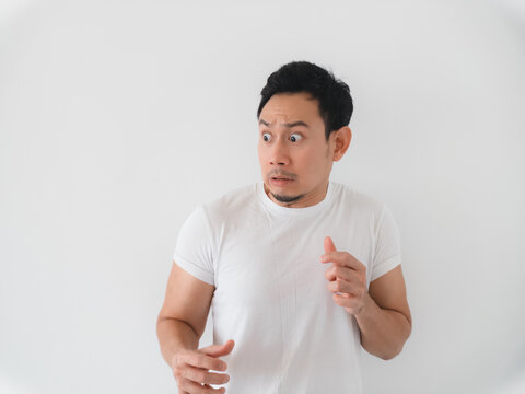 Expressive studio shot of surprised Asian man in casual attire