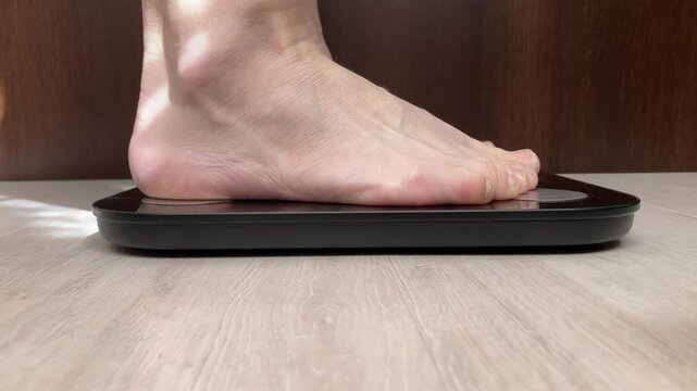 Woman measuring body weight using scale. The path to weight loss, self-control and the desire for change. Attention to your own health and body