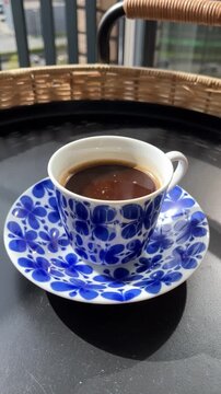 Ceramic&nbsp;blue&nbsp;coffee cup with natural steam smoke. Close-up of Smoke rises from cup, cup of coffee for breakfast in the morning time with warm light. Hot Coffee Drink Concept.