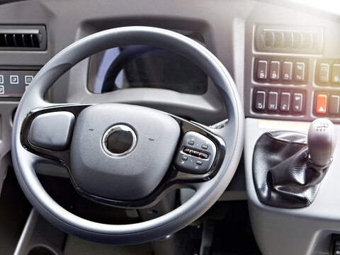 Bus driver cockpit with steering wheel and manual gearbox
